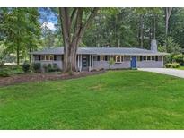 Charming single-story home featuring a well-manicured front yard and a covered front porch at 2463 Briarmoor Ne Rd, Atlanta, GA 30345