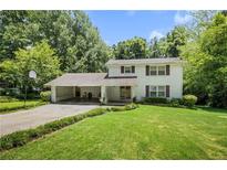 Charming two-story home features a brick exterior, a basketball hoop, and a large, well-manicured front lawn at 4389 Hambrick Way, Stone Mountain, GA 30083
