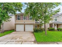 Charming two-story home with a two-car garage and a well-manicured lawn in a desirable neighborhood at 5865 El Segundo Way, Atlanta, GA 30349