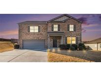 Charming two-story brick home with a well-maintained lawn and attached two-car garage at 8484 Glenview St, Douglasville, GA 30134