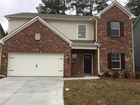 Charming two-story brick home featuring an attached garage and well-maintained front yard at 1392 Weatherbrook Cir, Lawrenceville, GA 30043