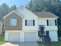 Charming two-story home with a stone facade and attached two-car garage at 4044 Robin Cir, Atlanta, GA 30349