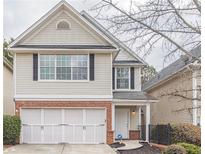 Charming two-story home with brick accents and attached garage on a landscaped lot at 646 Lakes Cir, Lithonia, GA 30058