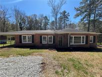 Charming brick ranch with black shutters and a covered side porch at 2103 River Rd, Ellenwood, GA 30294