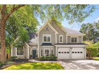 Charming two-story home with gray stucco exterior, well-manicured landscaping, and a two-car garage at 908 Lance Cir, Lawrenceville, GA 30043