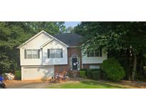 Charming two-story home features a brick facade, attached garage, and a well-maintained front yard at 95 Willow Tree Ter, Covington, GA 30016