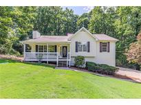 Charming single Gathering home featuring a well-manicured lawn and cozy front porch at 125 Ashbury Ct, Dallas, GA 30157
