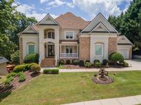 Beautiful two story home with brick and stucco exterior, manicured lawn, and tasteful landscaping at 4054 Lyon Blvd, Atlanta, GA 30331