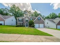 Charming two-story home with a manicured lawn and a two-car garage, nestled in a friendly neighborhood at 4815 Price St, Forest Park, GA 30297