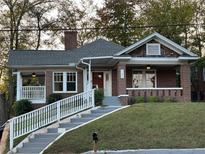 Charming brick home with a welcoming front porch and landscaped front yard at 1134 Donnelly Sw Ave, Atlanta, GA 30310