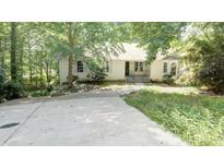 Charming single-Gathering home with mature trees and a spacious front yard and concrete driveway at 2773 Hawk Trace Ne Ct, Marietta, GA 30066