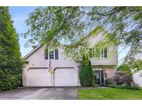 Charming two-story home featuring a two-car garage and well-manicured lawn, creating a welcoming curb appeal at 5035 Foxberry Ln, Roswell, GA 30075