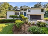 Beautifully landscaped two-story home features a lush lawn, charming shrubbery, and a blue front door at 2010 Barnes Mill Rd, Marietta, GA 30062