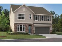 Charming two-story home with stone accents, gray siding, a two-car garage, and a well-manicured lawn at 7216 Eton Ln, Locust Grove, GA 30248