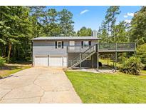 Two-story home with a two-car garage, deck, and siding at 1491 Stonington Ct, Villa Rica, GA 30180