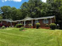 Charming brick home with a well-maintained lawn and mature trees, offering great curb appeal at 2933 Arlington Rd, East Point, GA 30344