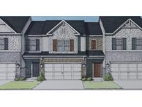 Charming townhome featuring a blend of brick and stone facade with a two-car garage and inviting entrance at 1163 Park Center Cir, Austell, GA 30168