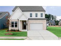 Charming two-story home with brick and white siding, manicured lawn, and a spacious two-car garage at 424 Madison Lakeview Dr, Acworth, GA 30102