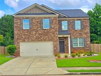 Charming two-story brick home with a well-manicured lawn and a two-car garage at 171 Shaker Hollow Drive Dr, Mcdonough, GA 30253