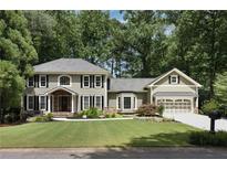 Charming two-story home with beautifully landscaped front yard, complemented by an attached two-car garage at 4249 Arbor Club Dr, Marietta, GA 30066