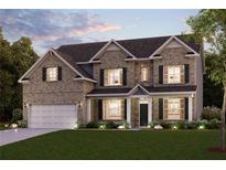 Charming two-story brick home with a well-manicured lawn and inviting front porch at 609 Elsa Lane Lot 76, Mcdonough, GA 30252