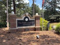 Attractive community sign for The Park at Ashford Condominiums with lush landscaping at 3650 Ashford Dunwoody Ne Rd # 413, Atlanta, GA 30319