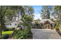 Charming home with lush landscaping, mature trees, and a circular driveway at 263 Mountainview Cir, Canton, GA 30115