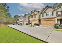 Charming townhomes featuring attached garages and well-manicured lawns at 2626 Sardis Chase Ct, Buford, GA 30519