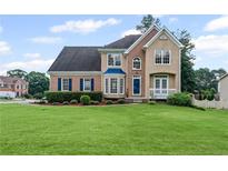 Charming two-story home featuring a well-maintained lawn and a welcoming front facade at 479 Rising Sun Path, Lawrenceville, GA 30043