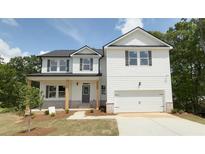 Charming two-story home with white siding, black shutters, and a spacious two-car garage at 5032 Falcon Pt, Douglasville, GA 30135