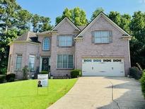 Charming two-story brick home with manicured lawn and a two car garage at 840 Milton Oaks Dr, Johns Creek, GA 30022