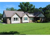 Charming home featuring a well-maintained lawn and a durable metal roof for long-lasting protection at 5225 Kings Hwy, Douglasville, GA 30135