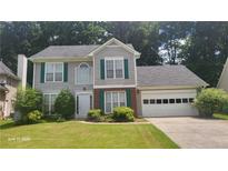 Charming two-story home featuring gray siding, green shutters and a well-maintained lawn at 3219 Roundfield Cir, Duluth, GA 30096