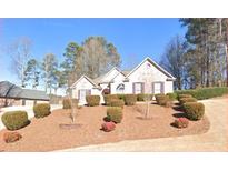 Well-maintained, single-story home with manicured landscaping and a symmetrical facade at 5035 Harbor Ridge Dr, Buford, GA 30518