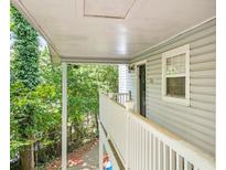 Inviting front porch featuring white railings, siding, and a glimpse of the home's entrance at 2110 Augusta Se Dr # 204, Marietta, GA 30067