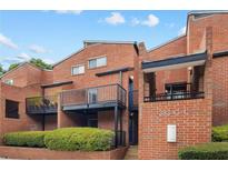 Brick townhome exterior with black wrought iron balconies and manicured landscaping at 383 Ralph Mcgill Ne Blvd # J, Atlanta, GA 30312