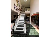 Bright foyer showcases a staircase and marble floors, leading to multiple rooms and a second story at 199 Scenic View Ln, Stone Mountain, GA 30087