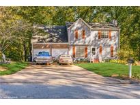 Charming two-story house with a well-manicured front yard and a two-car garage at 7490 Hunters Ridge Dr, Douglasville, GA 30134