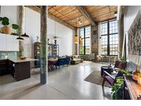 Spacious living room with high ceilings, exposed beams, and large windows providing ample natural light at 170 Boulevard Se # 221E, Atlanta, GA 30312