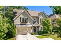 Charming two-story home with a well-manicured lawn, two-car garage, neutral siding, and black shutters at 1270 Briarwood Ne Rd, Atlanta, GA 30319