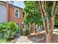Charming townhome with brick facade, mature landscaping, and inviting blue front door at 4177 Elder Ln, Duluth, GA 30096