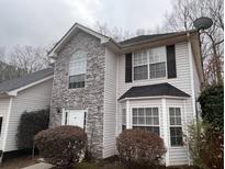 Charming two-story home featuring stone accents, vinyl siding, updated windows, and a well-maintained front yard at 2917 Duncan Pl, Decatur, GA 30034