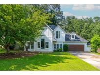 Charming two-story home with manicured lawn, lush landscaping, and a two-car garage at 5271 Oglethorpe Ct, Powder Springs, GA 30127