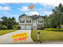 Charming two-story home with a well-manicured lawn and a spacious driveway at 185 Fox Run, Loganville, GA 30052