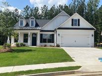 Charming one-story home with manicured lawn and attached two-car garage at 301 Brooke View Trail, Canton, GA 30115