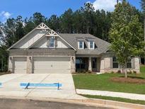 Charming single-story home featuring a brick facade, a three-car garage, and a well-manicured lawn at 354 Brooke View Trail, Canton, GA 30115