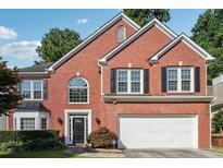 Charming two-story brick home with a well-manicured lawn and attached two car garage at 3272 Monarch Pine Dr, Peachtree Corners, GA 30071