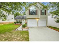 Charming two-story home with a well-manicured lawn, two-car garage, and inviting curb appeal at 191 Baywood Way, Hiram, GA 30141