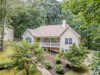 Inviting home with charming stone accents, a spacious porch, and lush landscaping, perfect for outdoor living at 217 Bridgewater Trl, Canton, GA 30115