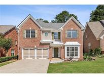 Charming two-story brick home featuring a well-manicured lawn and a two-car garage at 2761 Valley Spring Dr, Lawrenceville, GA 30044